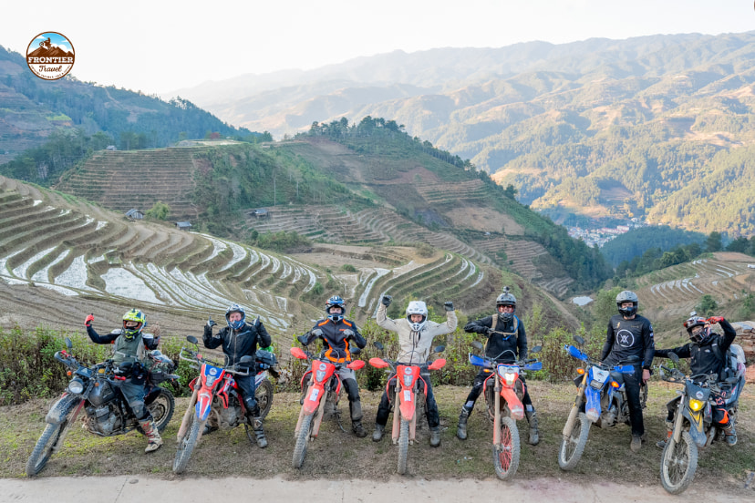 Riders taking a break during a long-distance Vietnam motorbike tour